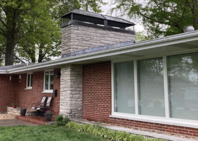Brick House with Black New Chimney Cap Installed